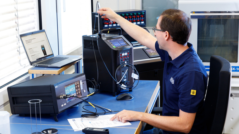 Employee in the calibration laboratory calibrating temperature measuring instruments.