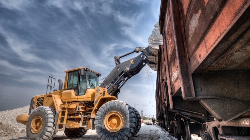 Wheel loader excavator with backhoe unloading clay